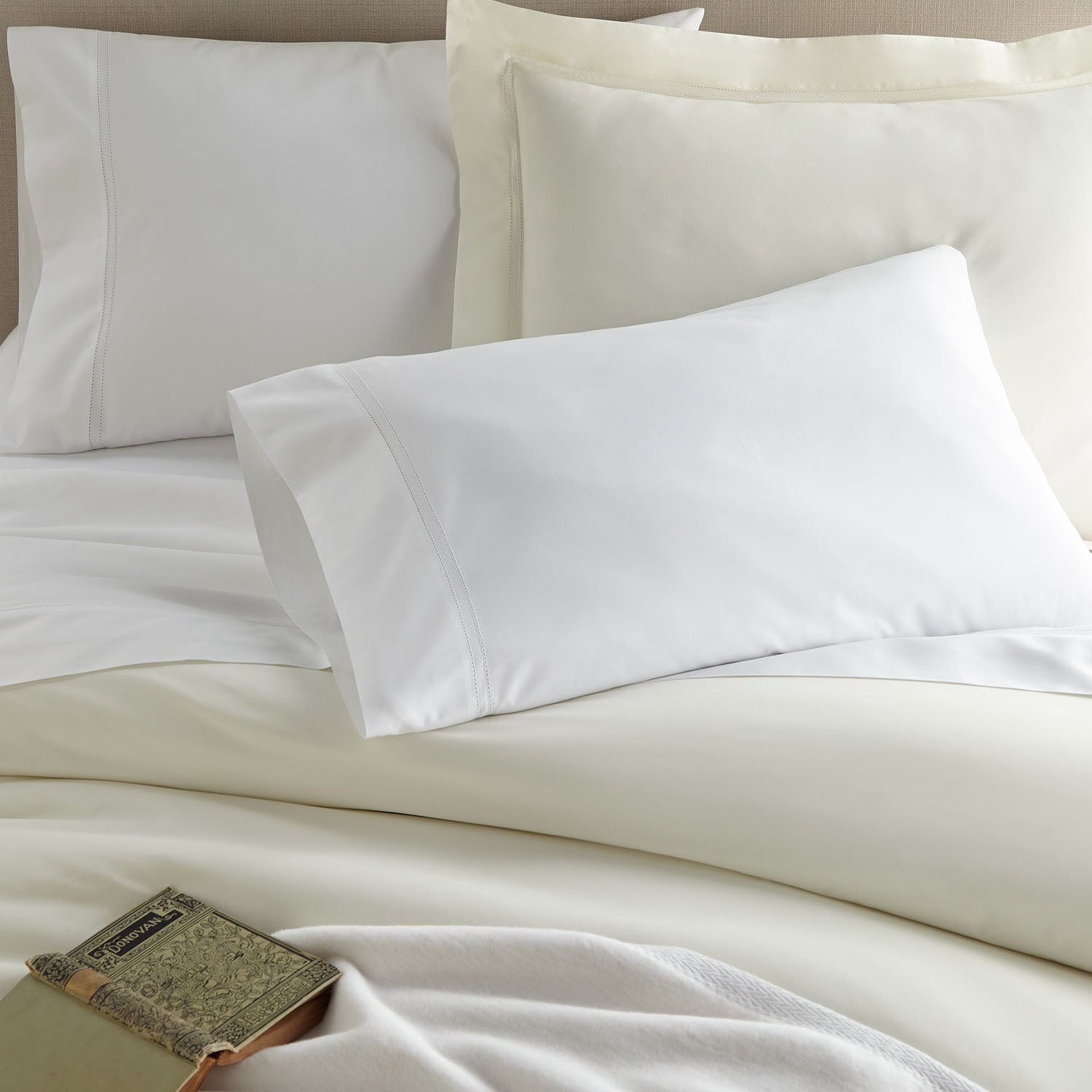 Peacock Alley Lyric percale cotton pillow sham styled in a bright bedroom