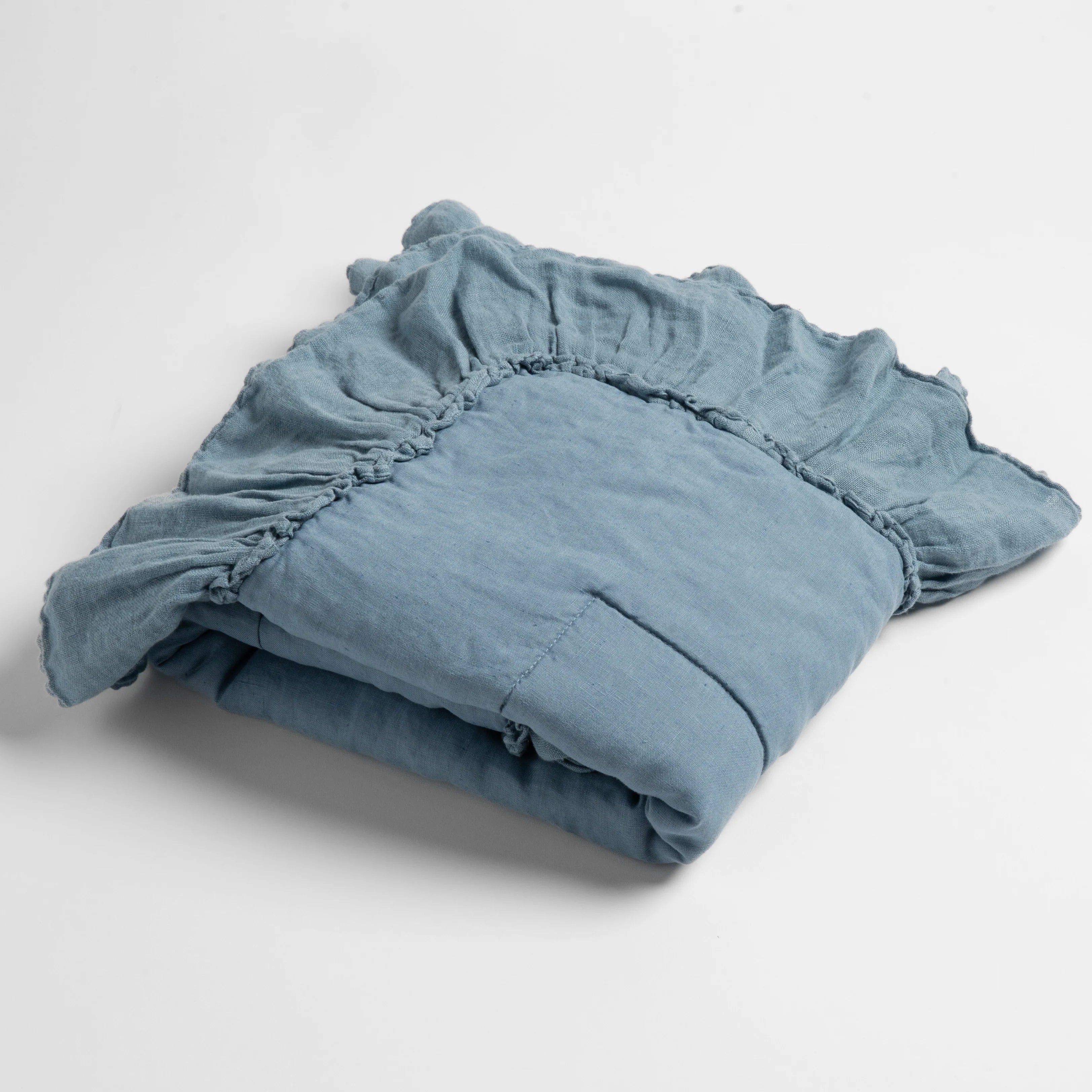 Bella Notte Linen Whisper Baby Blanket in linen whisper, stacked and folded for storage