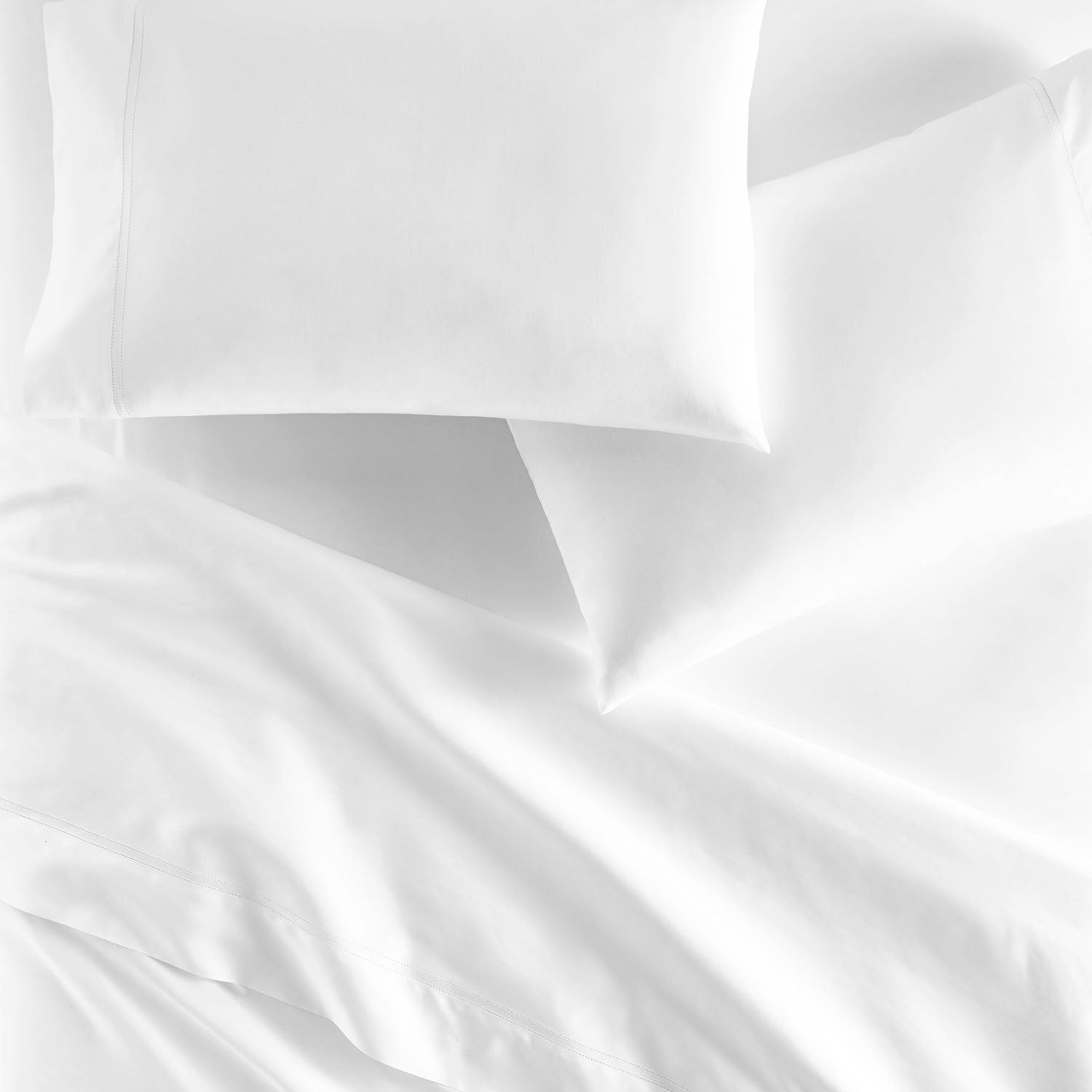 Peacock Alley Virtuoso Sateen Flat Sheet 600 thread count cotton sateen flat sheet, overhead flat-lay of the folded set