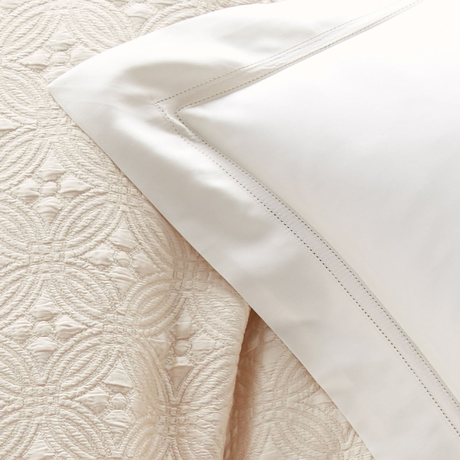 Peacock Alley Virtuoso Sateen Pillow Sham 600 thread count cotton sateen pillow sham, draped and layered detail on the bed